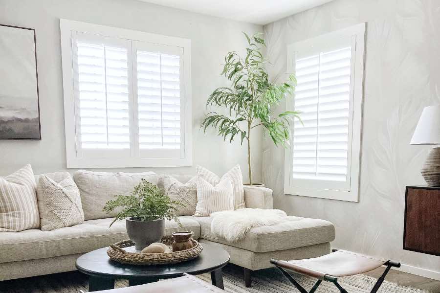 White Polywood shutters on windows of different sizes in a living room